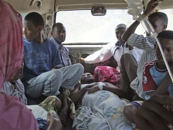 An injured man lies in an ambulance as he is taken to a hospital in Mogadishu, Somalia, on Sept. 24. Driving an ambulance in Mogadishu is a risky business as drivers face roadside bombs and sniper fire in an attempt to save people injured in this restive crumbling sea-side city